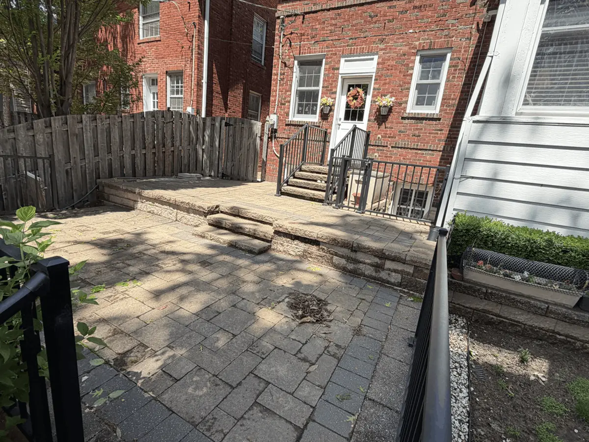Settled two-level paver patio with worn stone steps before replacement in Ballwin, MO