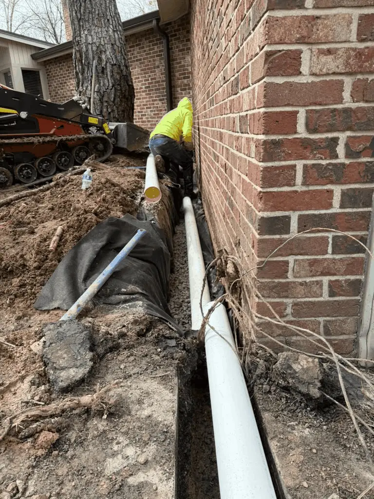 Trench dug along a Des Peres, MO home's foundation for a French drain