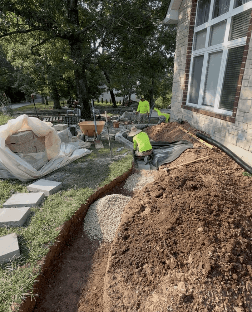 Stone edging was installed as part of the broader front-yard layout, helping define the planting areas and create cleaner transitions around the property.