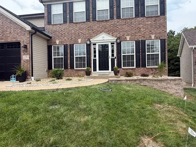 Retaining wall replacement in Oakville, MO with a capped Belgard wall and rock beds