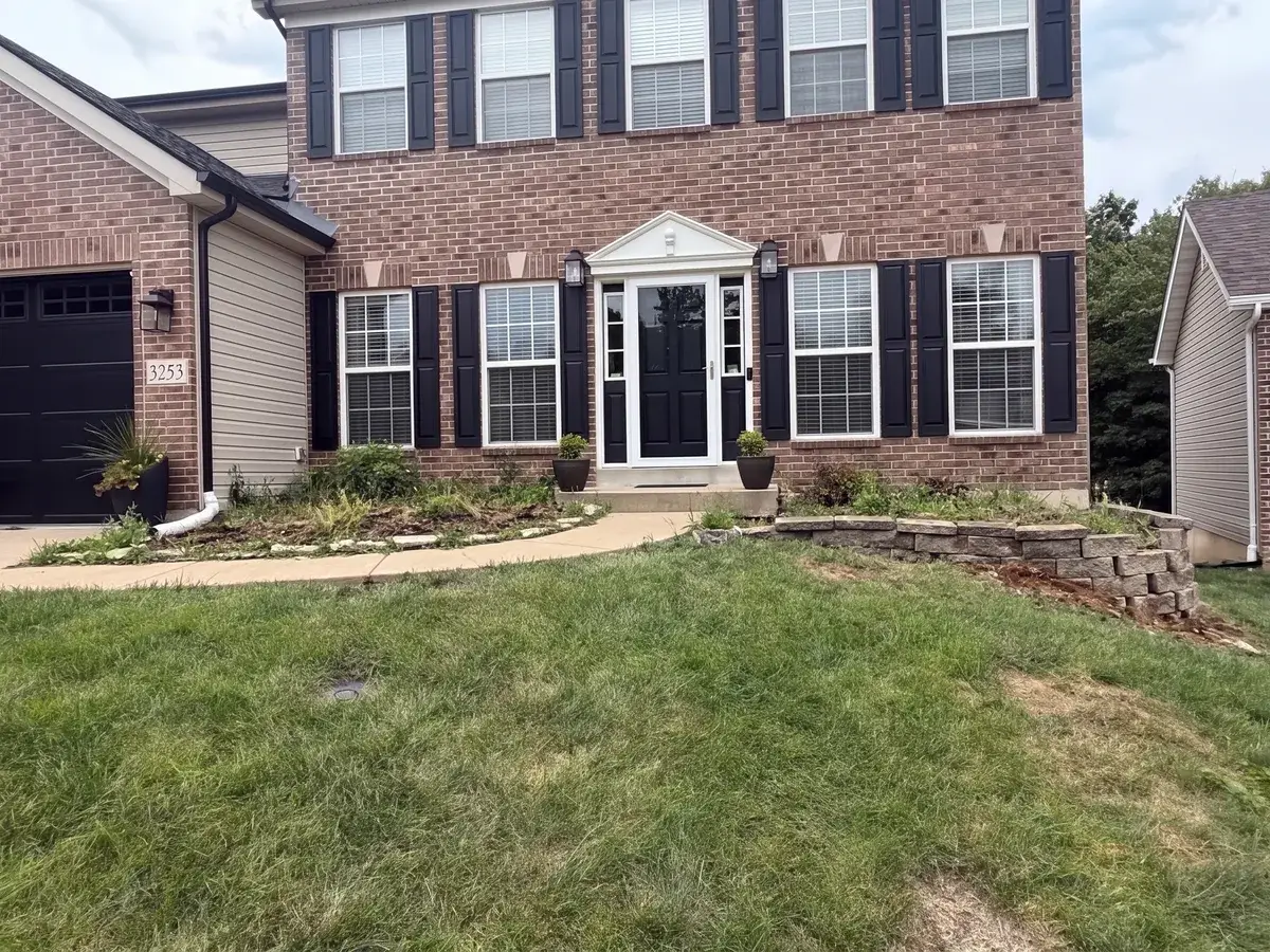 AI reconstruction of the failing front yard retaining wall before replacement in Oakville, MO