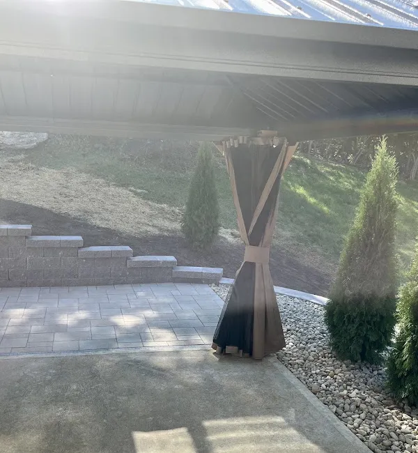 Paver patio and capped retaining wall seen from the original concrete patio in Valley Park, MO