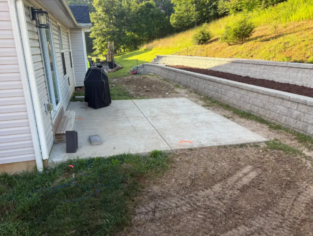 Small old concrete patio slab behind a home in Valley Park, MO