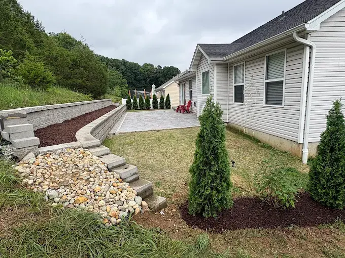Large Unilock paver patio with a soldier course border behind a home in Valley Park, MO